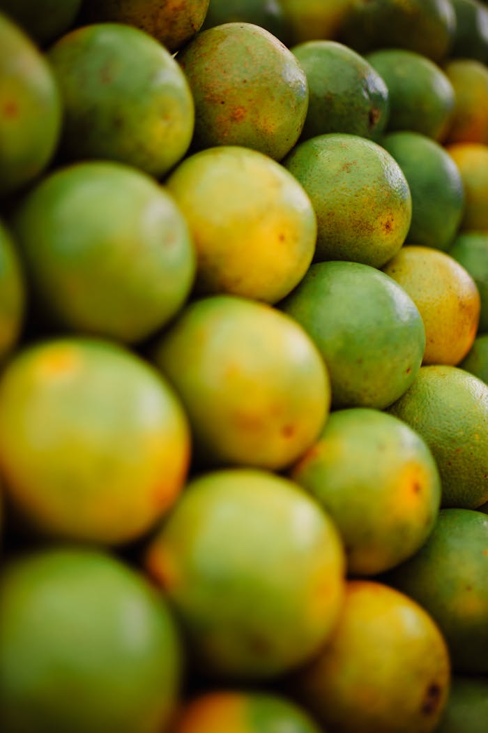 about-us-02 Stacked fresh green and yellow oranges creating a vibrant and refreshing scene.